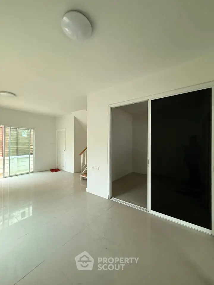 Spacious modern living area with sliding glass doors and natural light