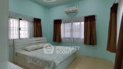 Spacious bedroom with modern air conditioning and natural light
