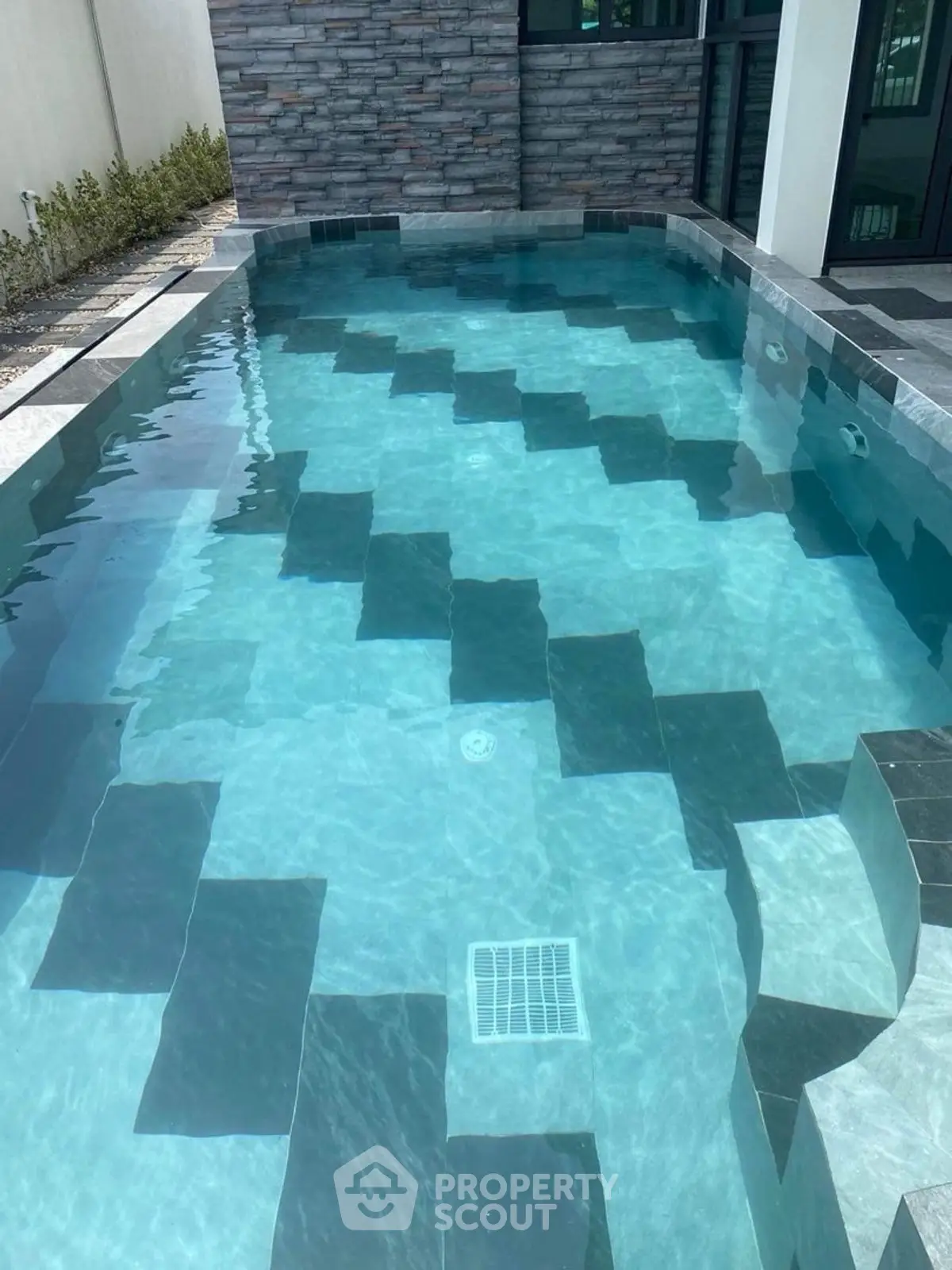 Luxurious private pool with modern tile design in upscale property