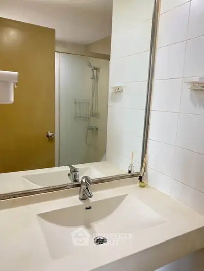 Modern bathroom with sleek sink and glass shower enclosure