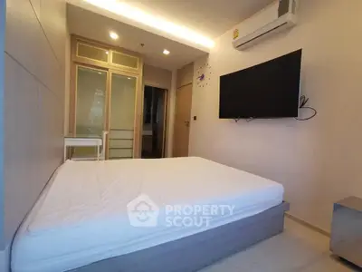 Modern bedroom with sleek design, featuring a wall-mounted TV and air conditioning for ultimate comfort.