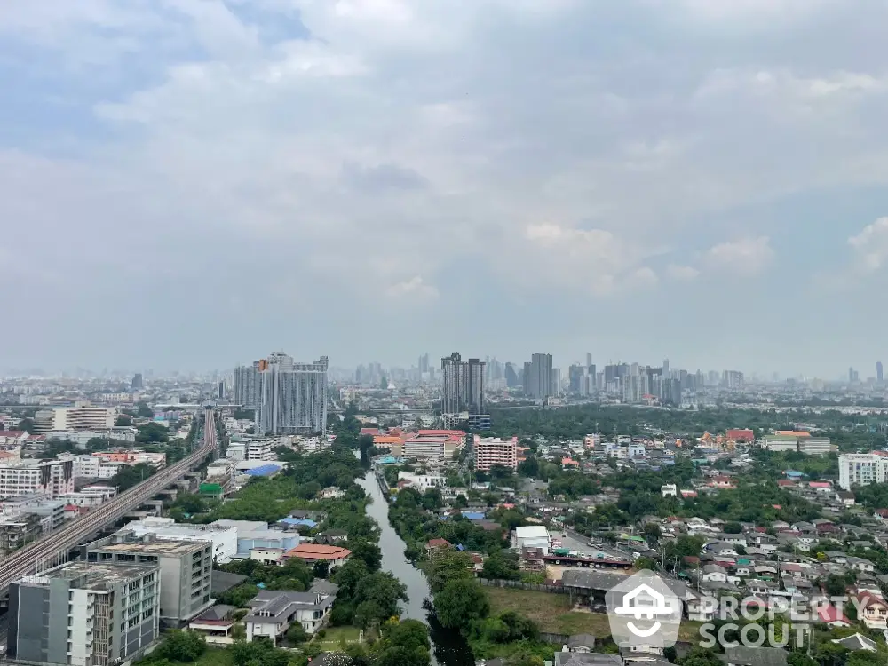 Stunning cityscape view from high-rise apartment overlooking urban skyline and river