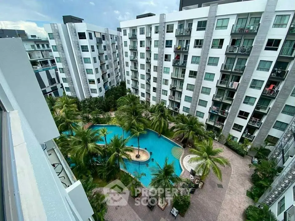 Modern apartment complex with lush courtyard and inviting pool view.