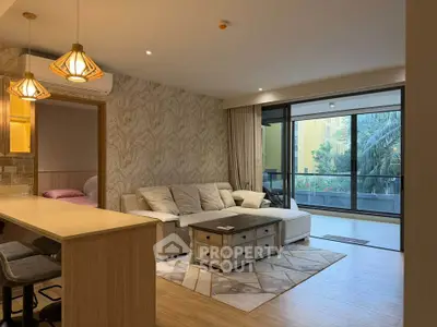Spacious modern living room with stylish decor and large balcony access.