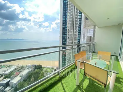 Stunning high-rise balcony with ocean view and modern outdoor seating area.