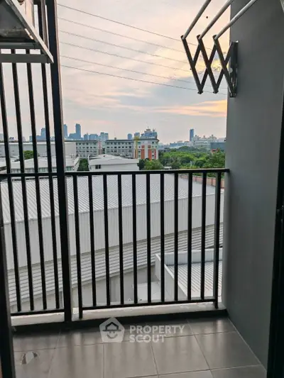 Modern balcony with city view and sleek railing design.