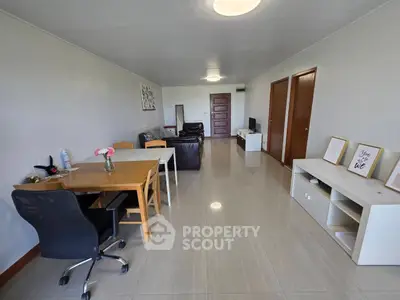 Spacious living room with modern furniture and sleek flooring, perfect for relaxation and entertainment.