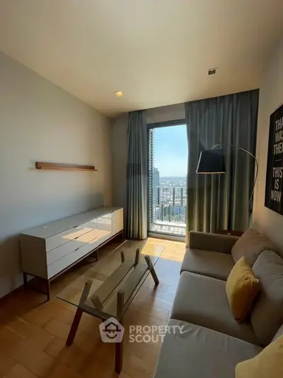 Modern living room with stylish furniture and city view from large window.