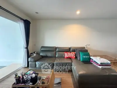 Spacious living room with modern leather sofa and natural light