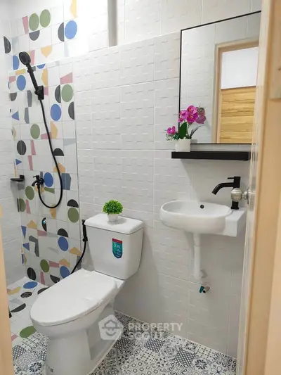 Charming bathroom with modern fixtures and colorful tile accents