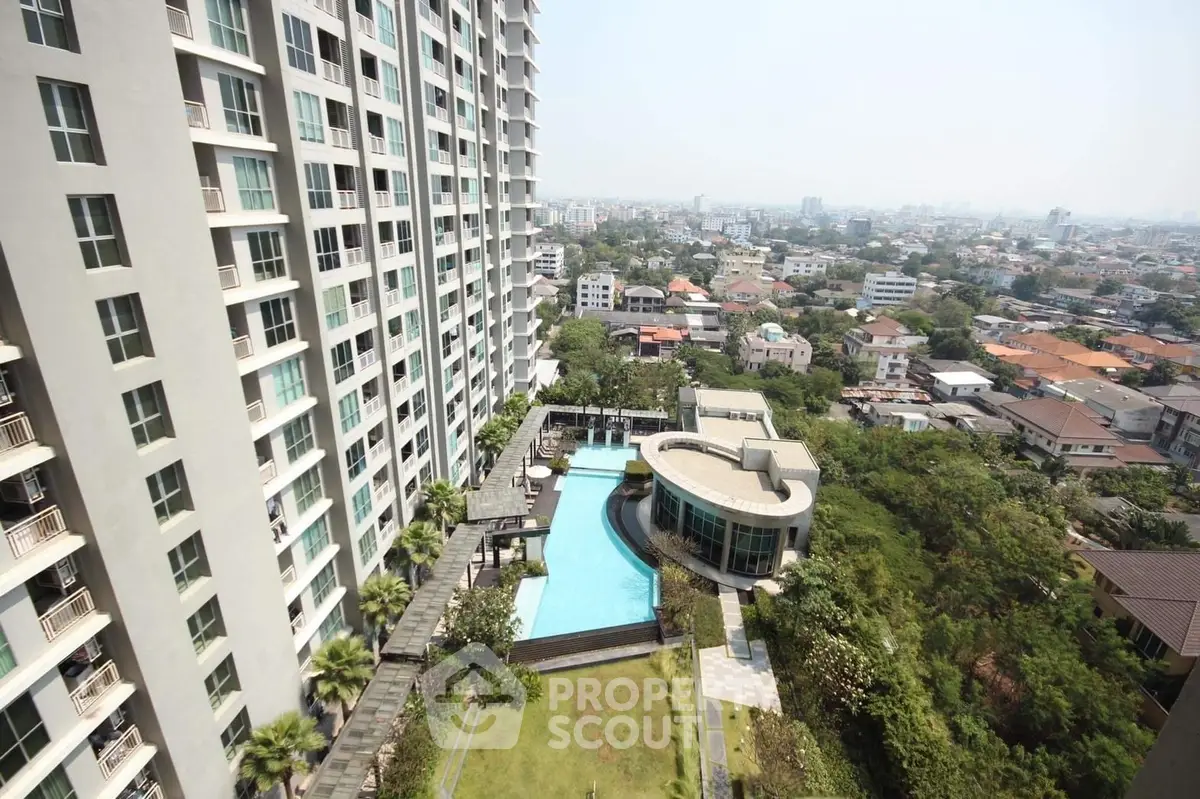 Stunning high-rise building with pool and lush garden offering panoramic city views.