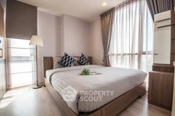 Spacious modern bedroom with large windows and stylish decor