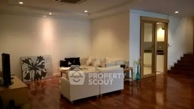 Spacious living room with modern decor and wooden flooring