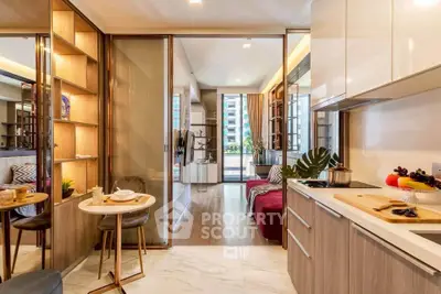 Modern open-layout kitchen and living area with stylish decor and natural light.