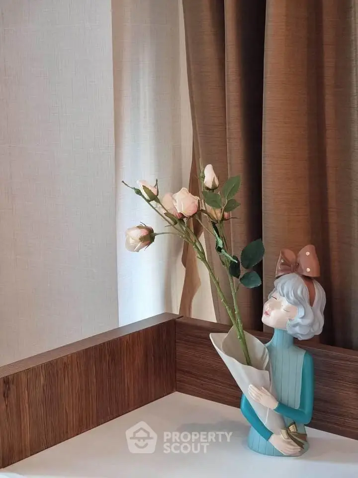 Charming corner with elegant decor featuring a stylish vase and flowers, perfect for enhancing interior aesthetics.