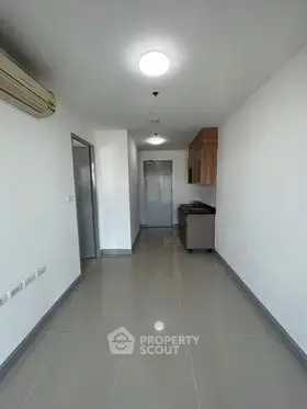 Spacious modern apartment hallway with sleek tiled flooring and minimalist design.