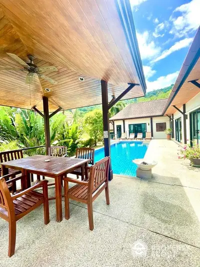 Luxurious villa with private pool and outdoor dining area in tropical setting