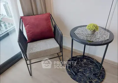 Stylish modern interior with cozy chair and elegant side table near a window, perfect for relaxation.