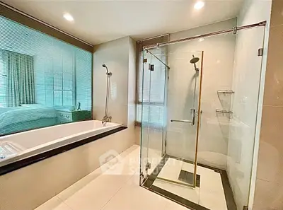 Luxurious bathroom with glass shower and modern bathtub in elegant home.