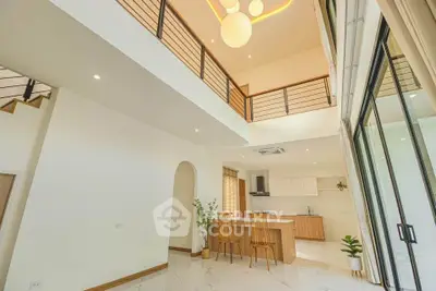 Spacious modern living area with high ceilings and open kitchen layout