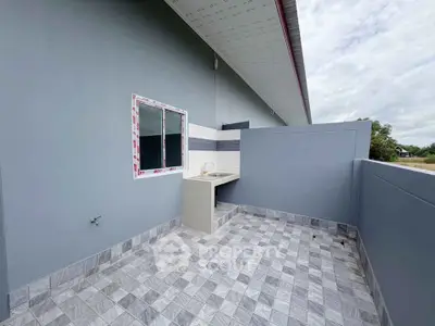 Modern outdoor laundry area with tiled flooring and sleek design