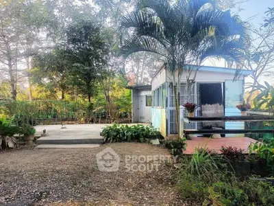 Charming rural property with lush garden and cozy outdoor deck, perfect for nature lovers.