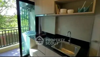 Modern kitchen with balcony view and sleek cabinetry
