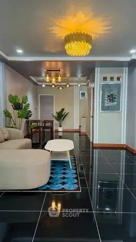 Modern living room with elegant lighting and sleek black tile flooring