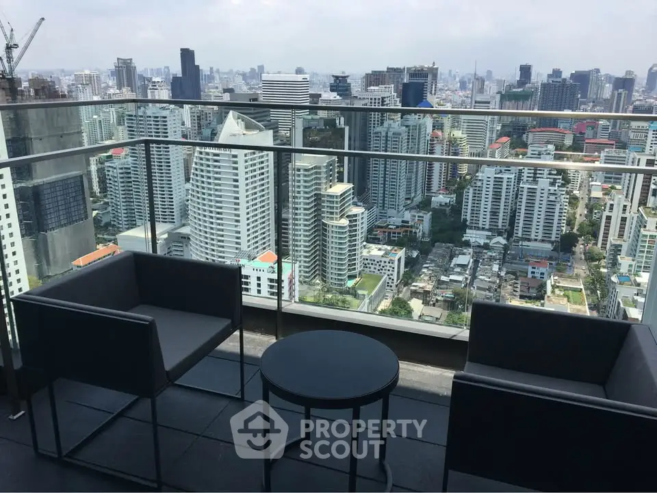 Stunning cityscape view from a modern balcony with sleek furniture, perfect for urban living.
