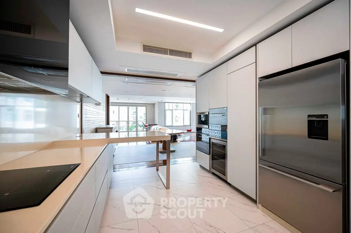Modern kitchen with sleek appliances and open layout in luxury apartment
