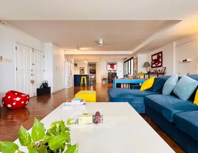 Spacious living room with modern decor and vibrant blue sofa