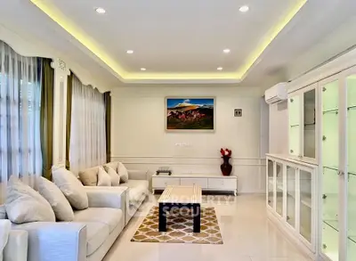 Elegant living room with modern decor and ambient lighting, featuring a cozy sofa and stylish artwork.