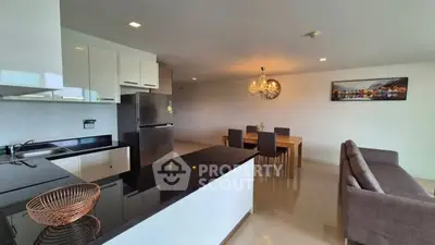 Spacious modern kitchen with open layout and elegant dining area in a stylish apartment.