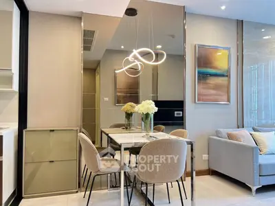 Modern dining area with elegant lighting and stylish decor in a contemporary apartment.