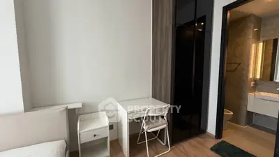 Modern bedroom with study area and ensuite bathroom in sleek apartment