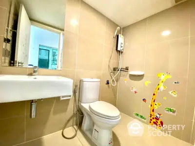 Modern bathroom with beige tiles and playful giraffe wall stickers