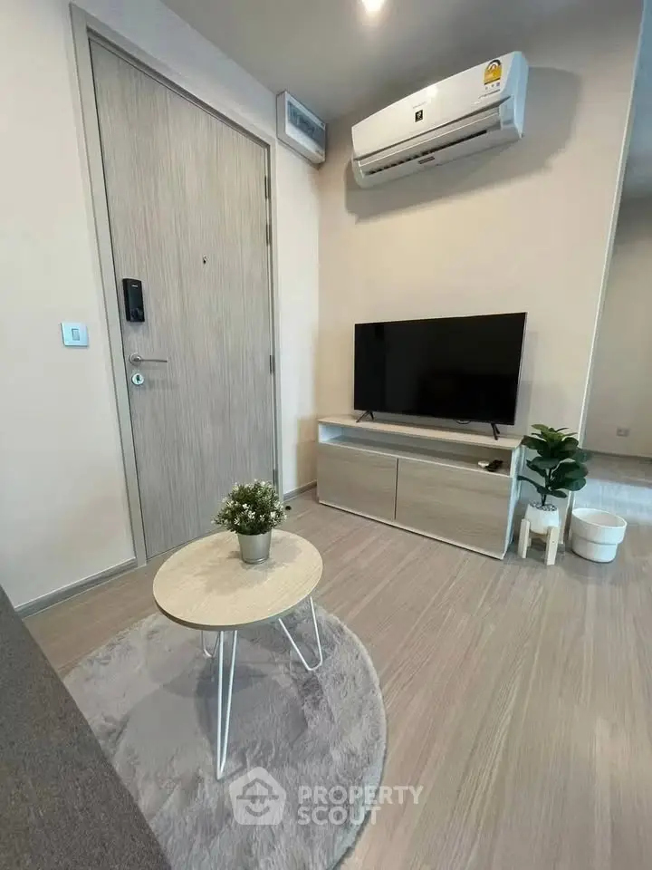 Modern living room with sleek TV setup and air conditioning, perfect for cozy relaxation.
