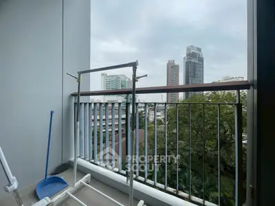 City view from a modern balcony with railing and drying rack, perfect for urban living.