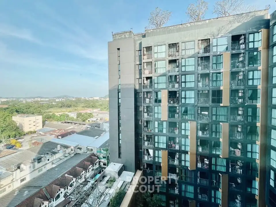 Modern high-rise building with scenic city view and lush greenery, perfect for urban living.