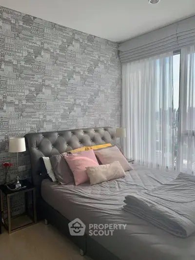 Chic modern bedroom with city view, featuring stylish wallpaper and elegant decor.