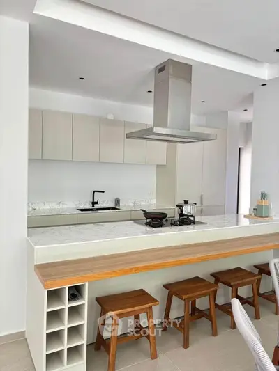 Modern kitchen with island seating and sleek cabinetry in a stylish home