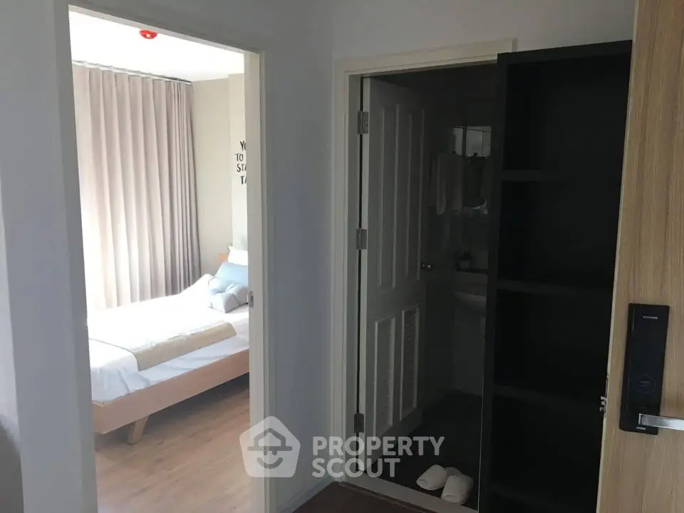 Cozy bedroom with modern decor and adjacent bathroom in a stylish apartment.