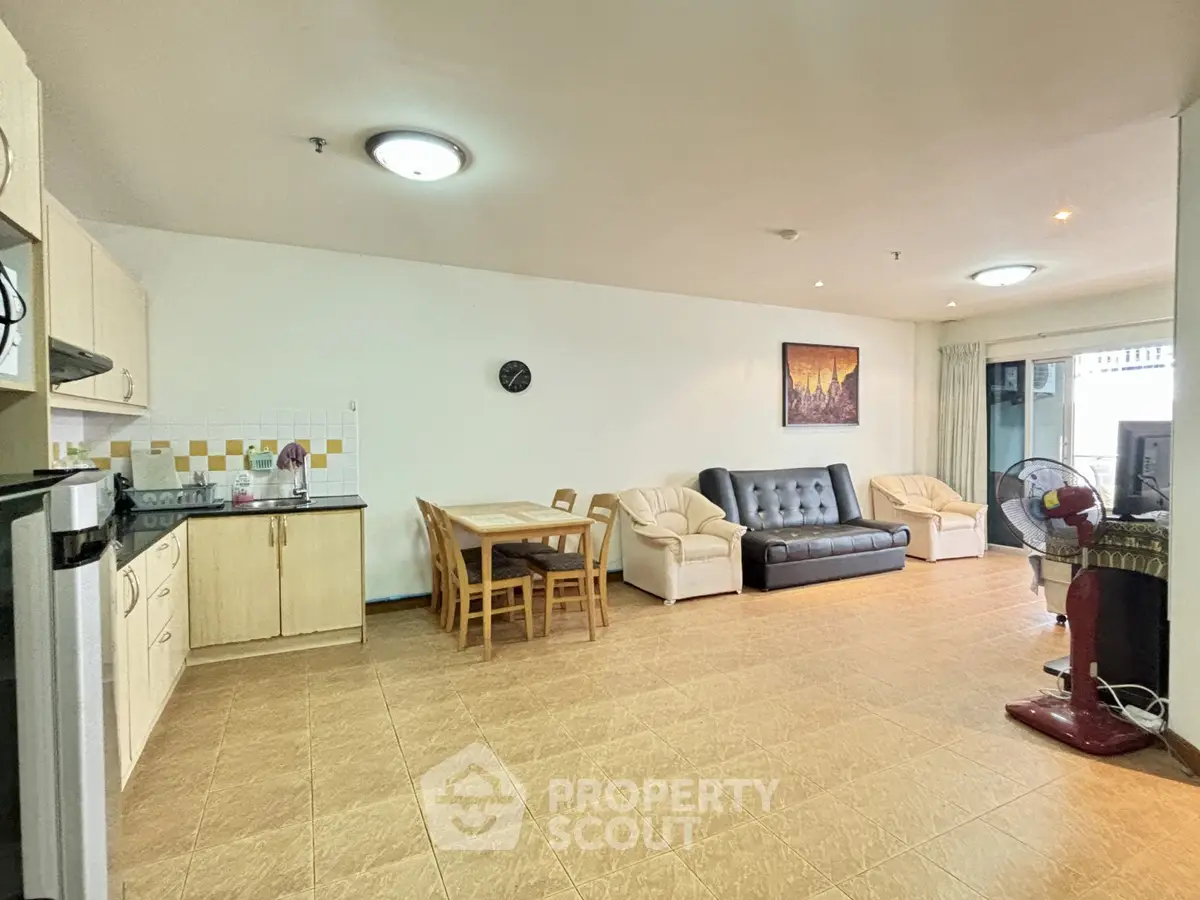 Spacious living room with modern furniture and open kitchen layout