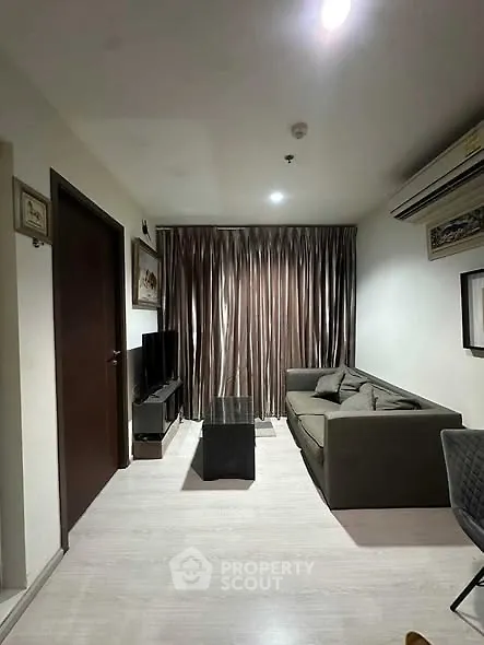 Modern living room with sleek furniture and elegant curtains