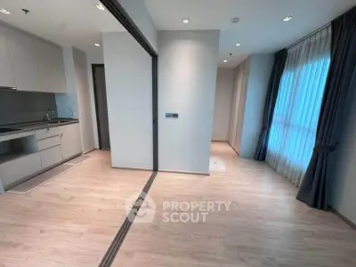 Modern apartment interior with sleek kitchen and large windows