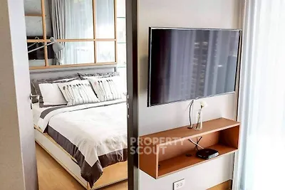 Modern bedroom with wall-mounted TV and stylish decor
