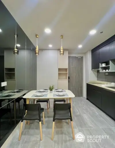 Modern kitchen with sleek black cabinetry and elegant dining setup