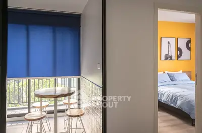 Modern apartment with vibrant bedroom and cozy dining area with blue accents.