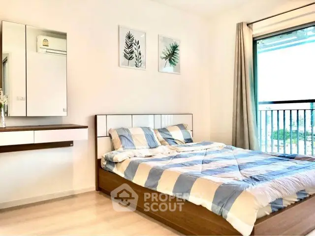 Bright and airy bedroom with modern decor and large window view.