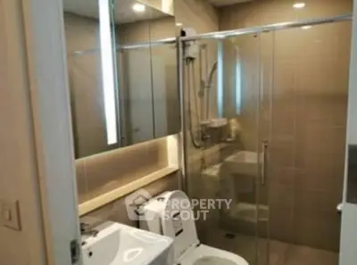 Modern bathroom with glass shower and sleek fixtures